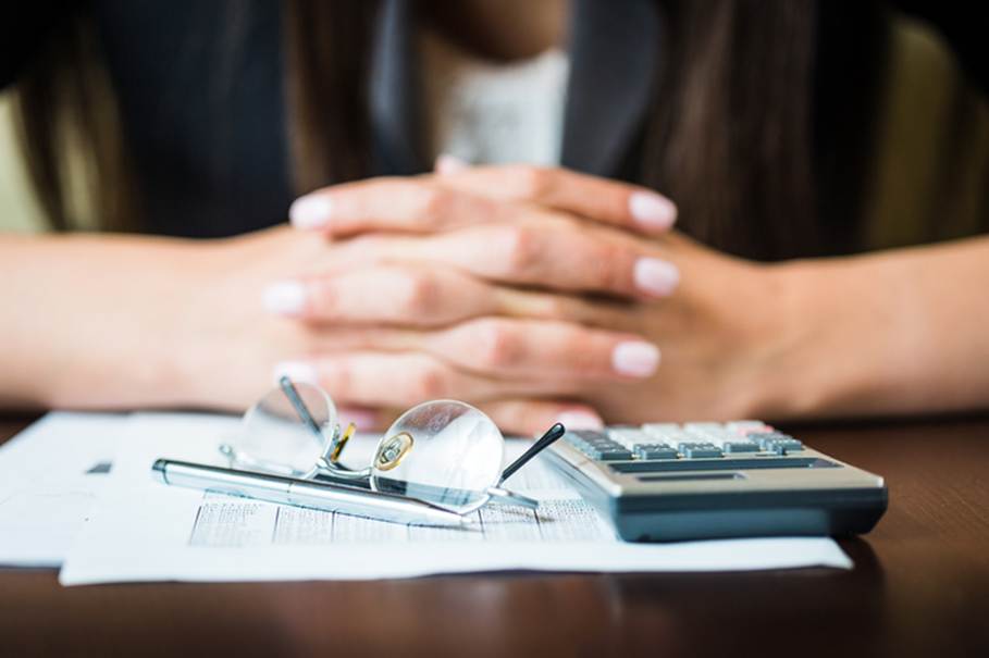 Woman looking at paperwork - Unpaid Wages